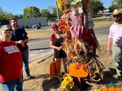 Garden Club members Rollanda Cothran, Buzzy Barnette, Eve Kneeland and Mason Dyess work to spruce up Greensboro with fall decorations as part of a recent club beautification project. The Garden Club will hold a fall plant sale this Saturday at Greensboro First United Methodist Church.