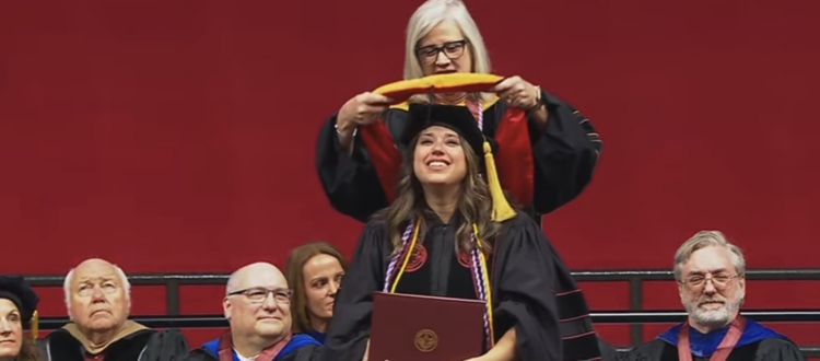Dana Gentry Eicher with her faculty advisor, Dr. Amy Lee, at the doctoral hooding ceremony during the University of Alabama commencement at Coleman Coliseum