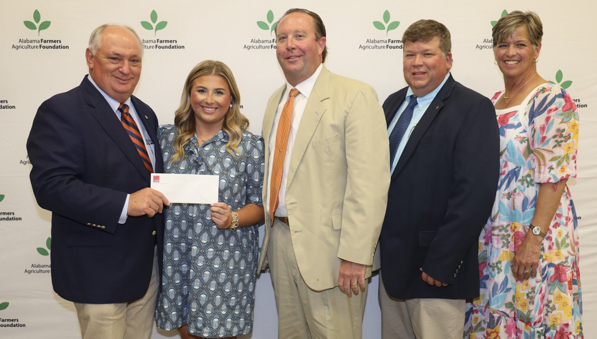 Laura Kyser, second from left, receives the John C. Jay Jr. Memorial Scholarship Sept. 21 at Lazenby Farms in Auburn. From left are Federation President Jimmy Parnell, Kyser, Hale County Farmers Federation board member Townsend Kyser, Federation District 8 Director Stewart Koon and Federation Southwest Area Vice President Hope Cassebaum.